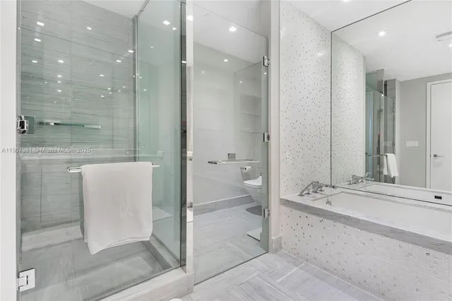 a bathroom with a bathtub and a shower