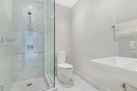 a bathroom with a tub double sink and mirror