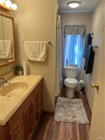 a bathroom with a sink toilet a mirror and shower