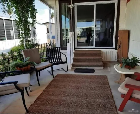 a view of two chairs in the patio