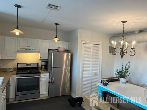 a kitchen with refrigerator and microwave