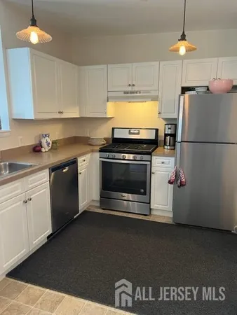 a kitchen with a stove a refrigerator and a sink