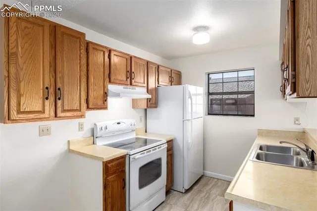 a kitchen with a refrigerator sink and stove