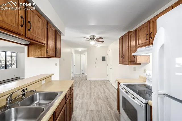 a kitchen with a sink and a refrigerator