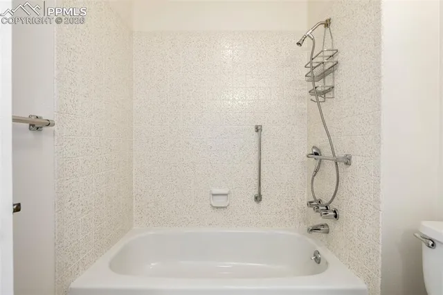 a bathroom with a bath tub with a shower