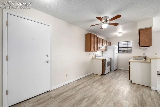 a view of a kitchen with a sink dishwasher and a refrigerator