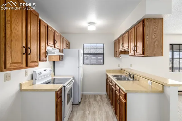 a kitchen with a sink stove and cabinets