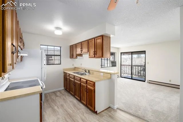 a kitchen with stainless steel appliances granite countertop a stove and a sink