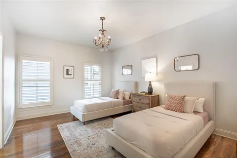 a spacious bedroom with two beds and a window