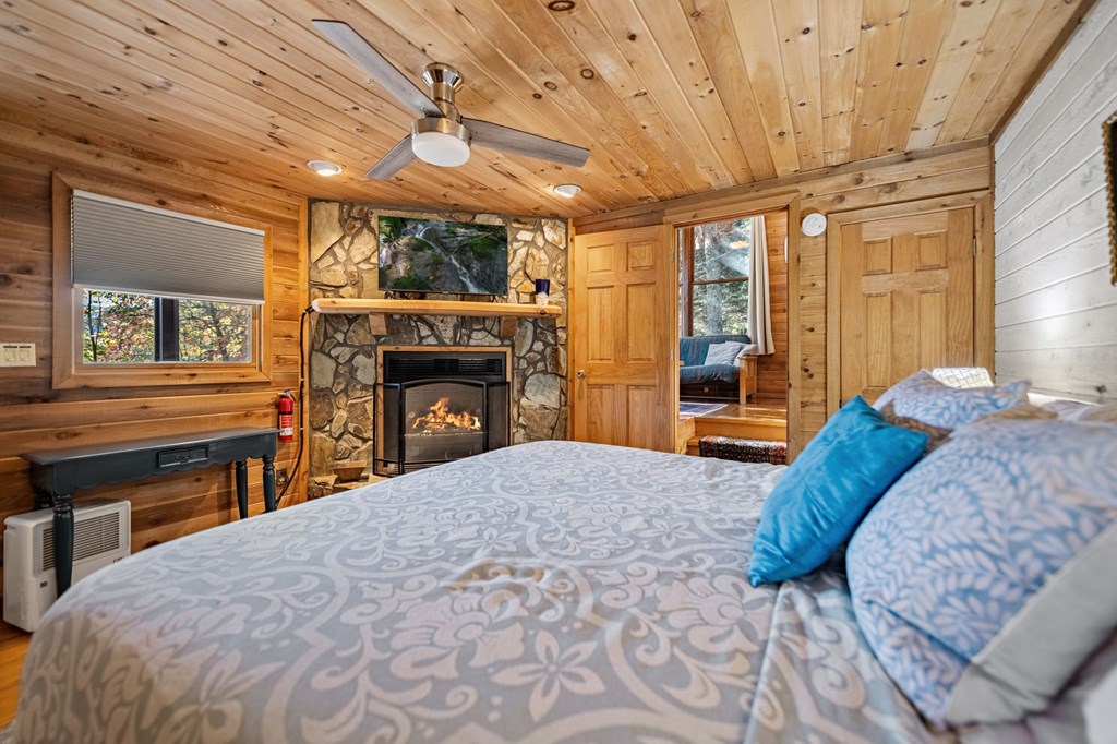 117 Horse Trail Blue Ridge, GA 30513 - Photo 27 of 50 a bed room with a bed and a fireplace