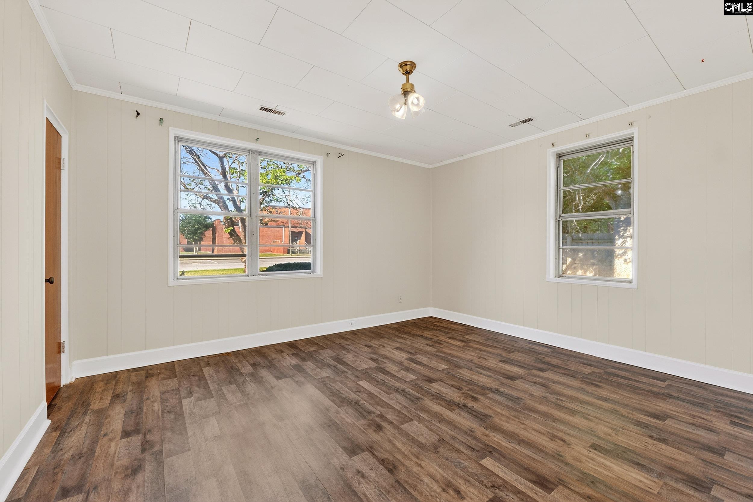 729 Magnolia Street Pelion, SC 29123 - Photo 14 of 32 a view of an empty room with wooden floor and a window