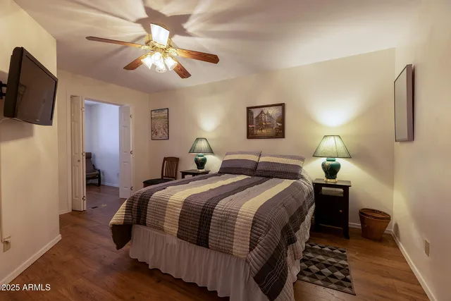 a bedroom with bed and a chandelier