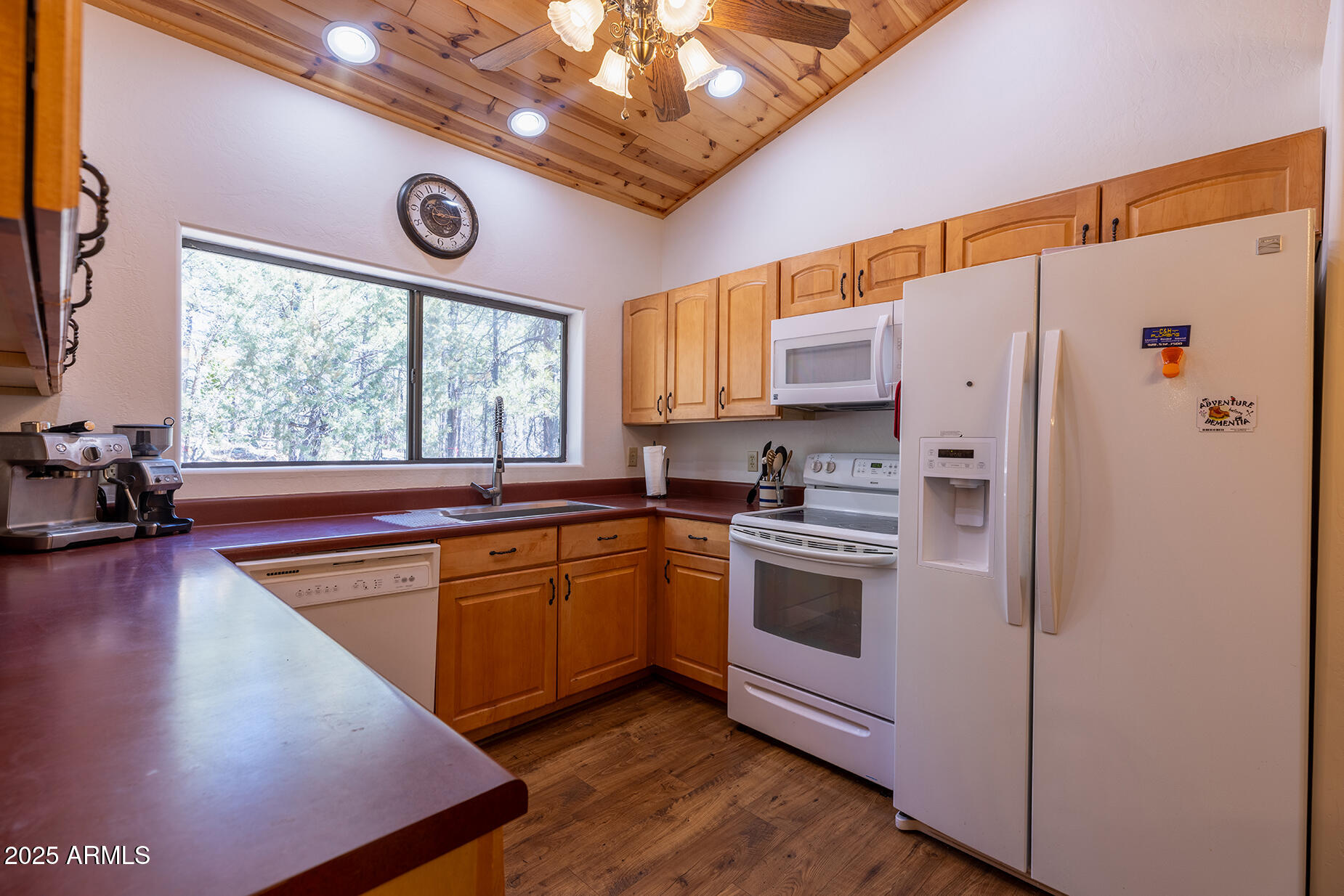 2358 Rainbow Lane Pinetop, AZ 85935 - Photo 25 of 50 a kitchen with stainless steel appliances granite countertop a refrigerator a sink dishwasher a stove and white countertops with wooden floor