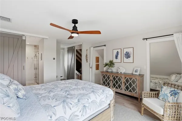a bedroom with a bed and a chandelier