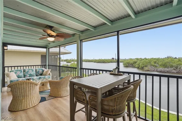 a view of a balcony with furniture and wooden floor