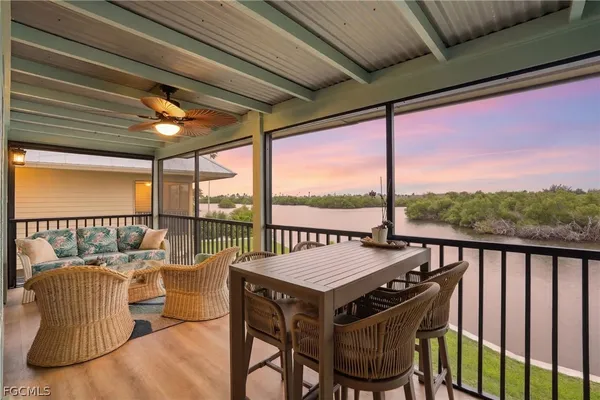 a view of a balcony with furniture and wooden floor