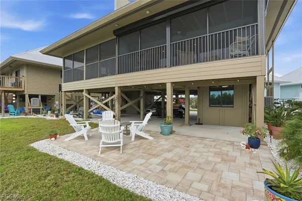 a view of a house with backyard porch and sitting area