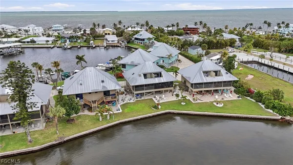 an aerial view of a house with a garden and lake view