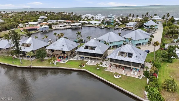 an aerial view of a house with a lake view