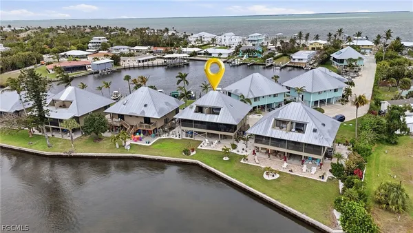 an aerial view of a house with a swimming pool yard and outdoor seating