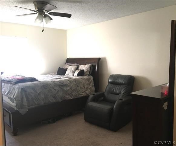 123 Turtle Creek Road, Unit 5 Charlottesville, VA 22901 - Photo 11 of 18 a bedroom with a bed and ceiling fan