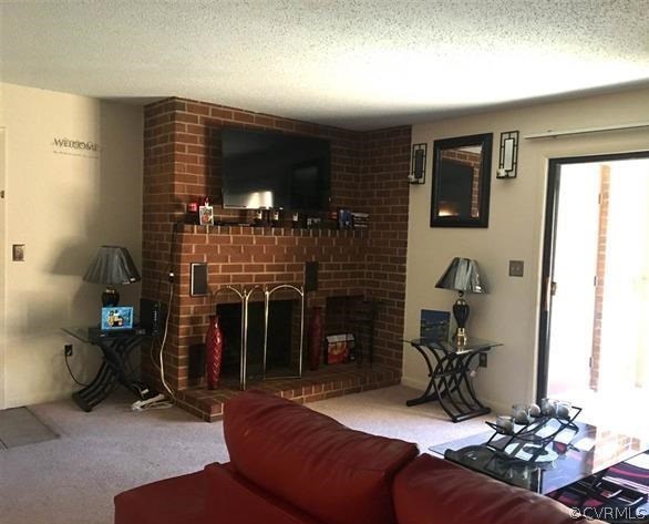 123 Turtle Creek Road, Unit 5 Charlottesville, VA 22901 - Photo 2 of 18 a living room with furniture and a fireplace