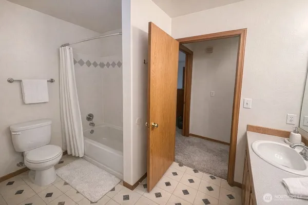 a bathroom with a toilet sink and a shower