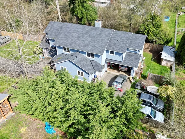 an aerial view of a house with a yard