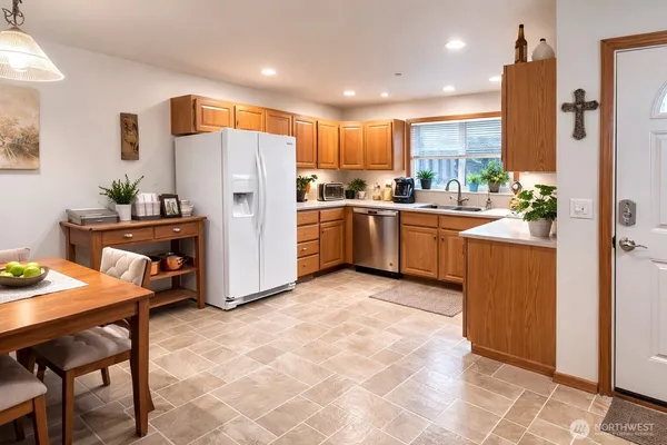 a kitchen with sink refrigerator and cabinets