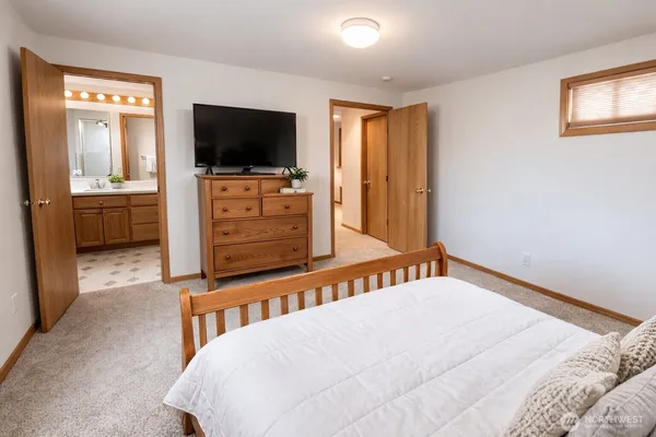 a bedroom with a bed and a flat screen tv