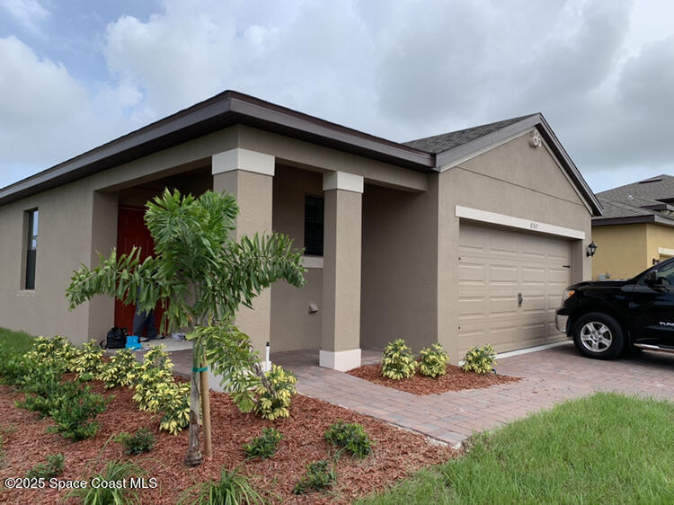 a front view of a house with garden