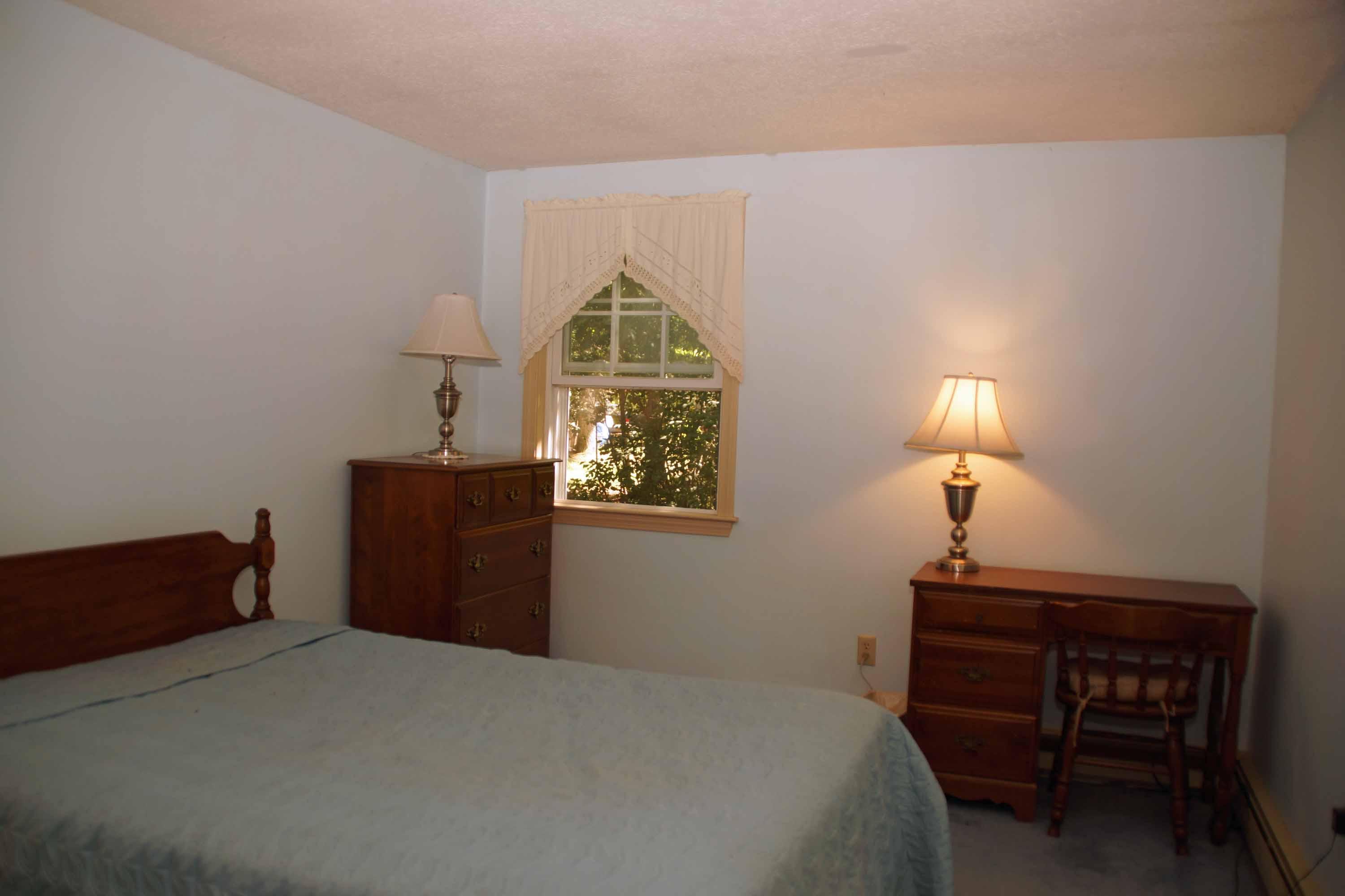 111 Azalea Drive Harwich, MA 02645 - Photo 13 of 26 a bedroom with a bed and a window