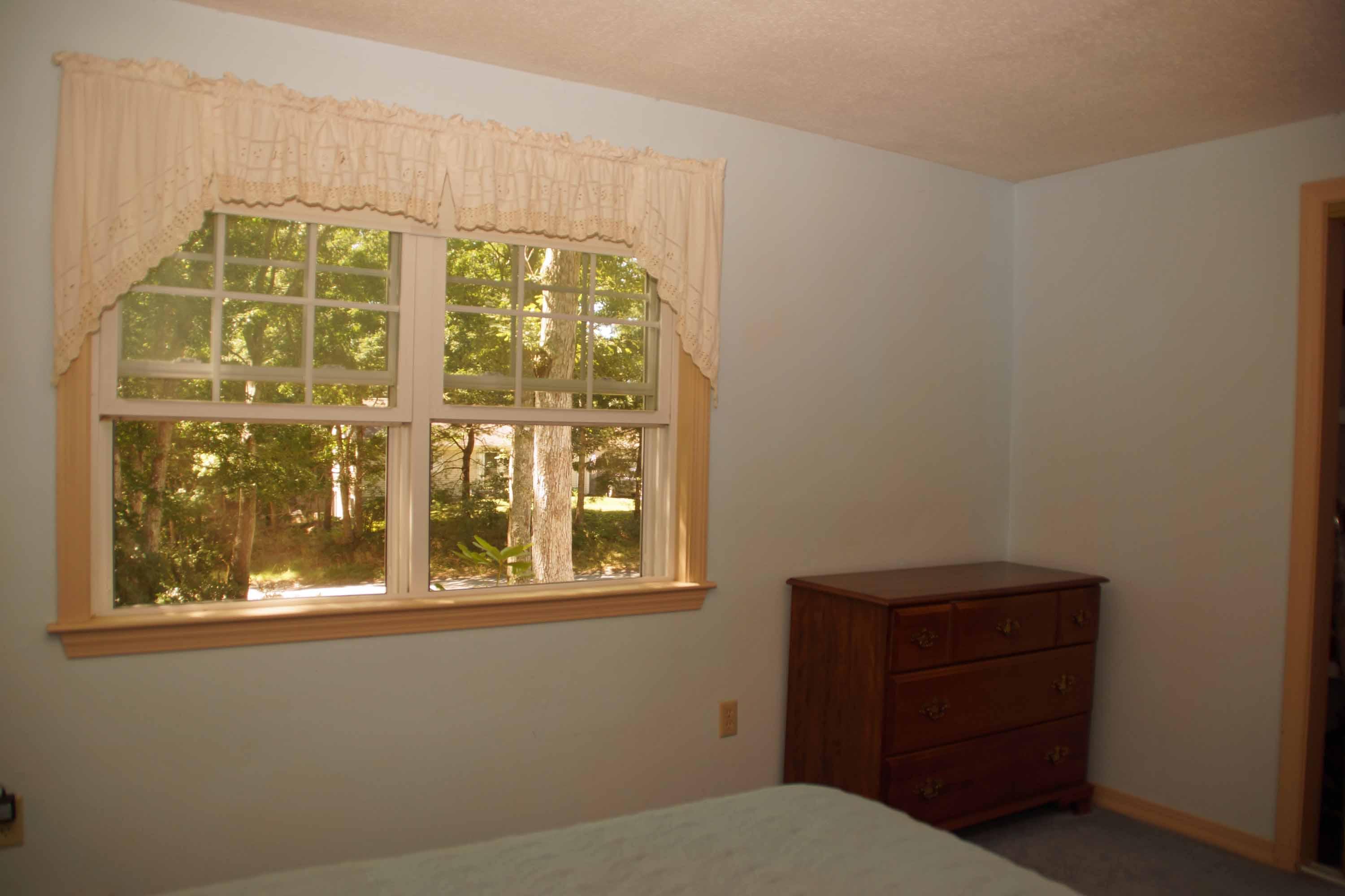 111 Azalea Drive Harwich, MA 02645 - Photo 14 of 26 a bedroom with a bed and a window