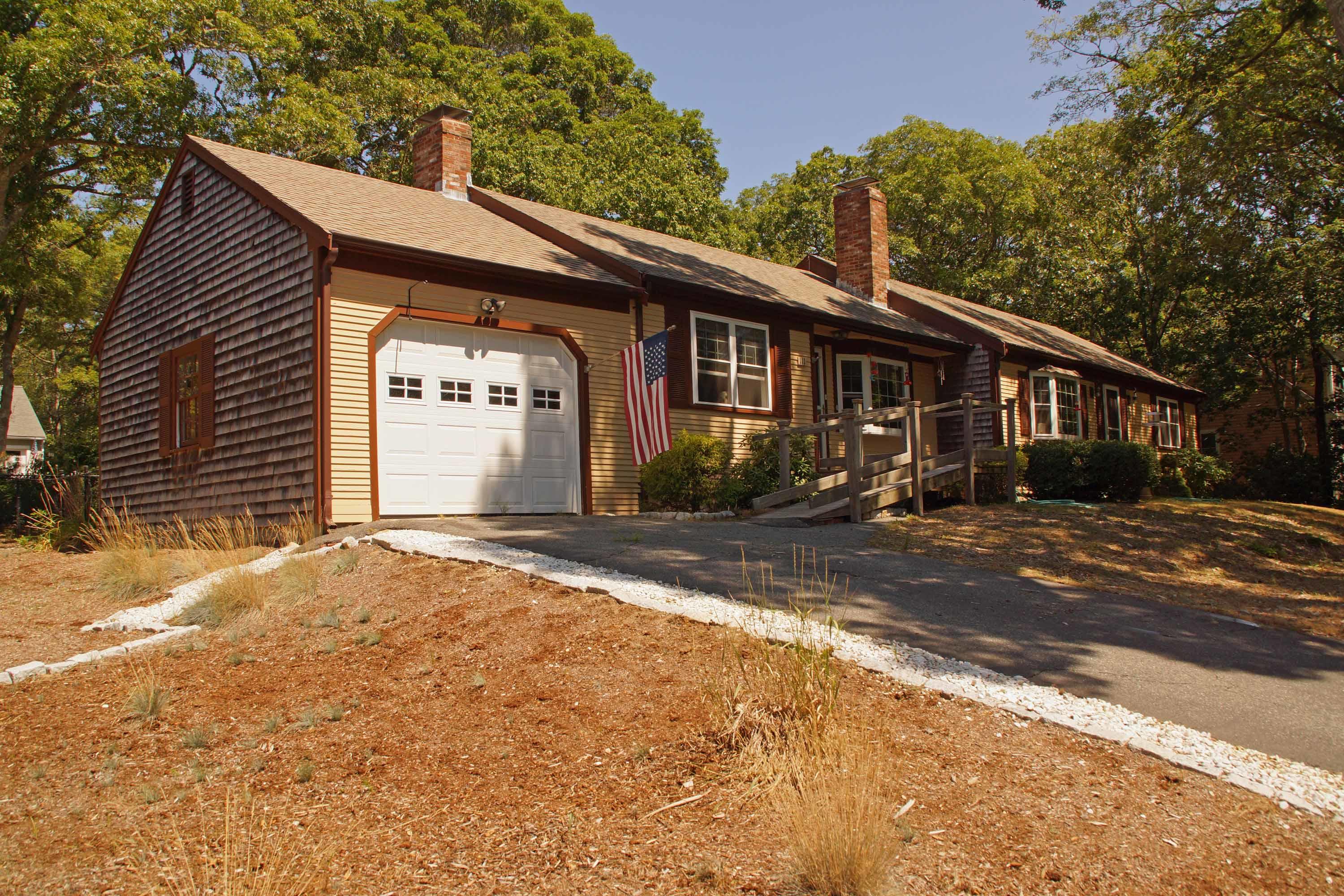 111 Azalea Drive Harwich, MA 02645 - Photo 15 of 26 a front view of a house with a yard and garage