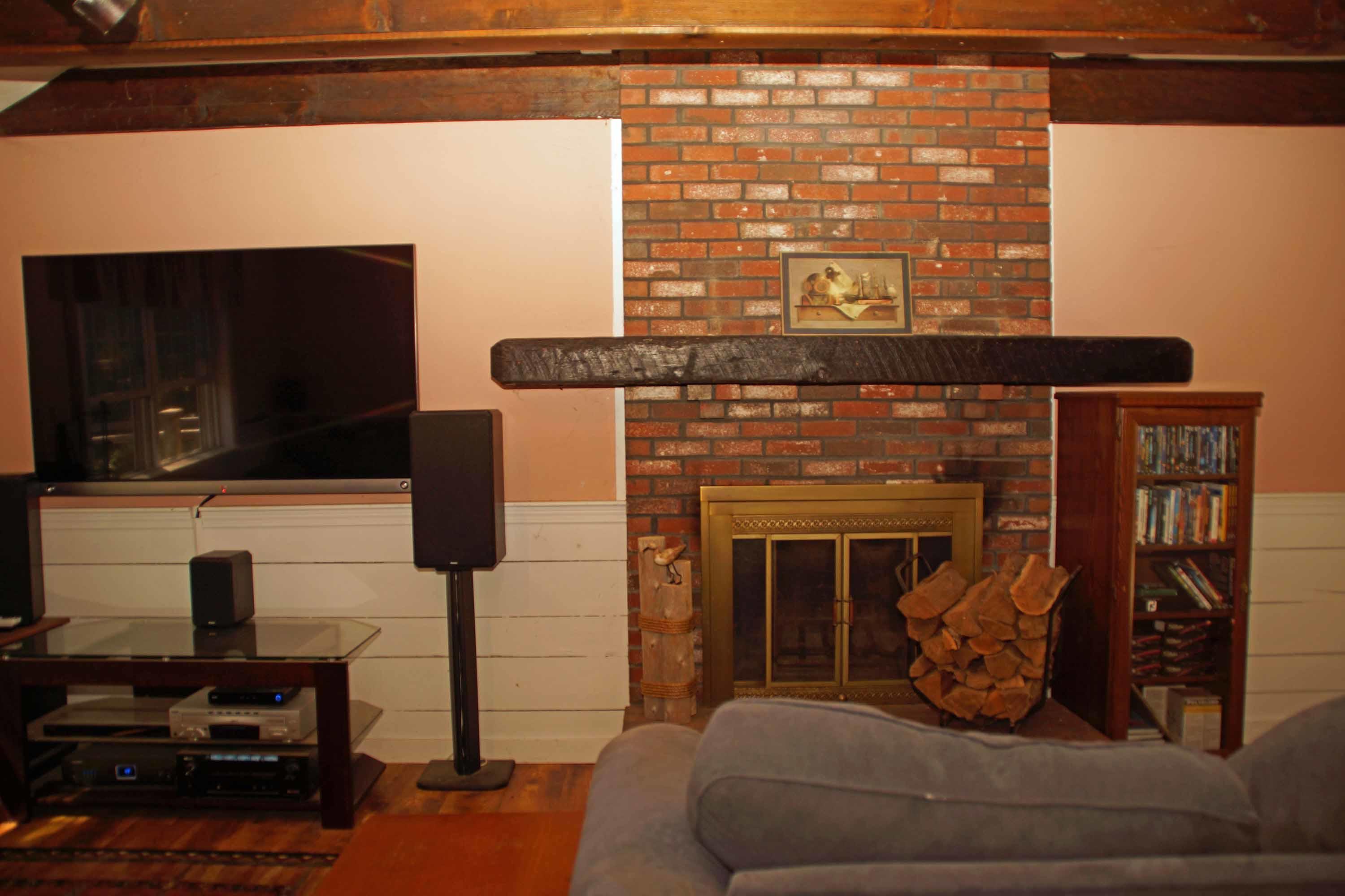 111 Azalea Drive Harwich, MA 02645 - Photo 5 of 26 a living room with furniture a flat screen tv and a fireplace
