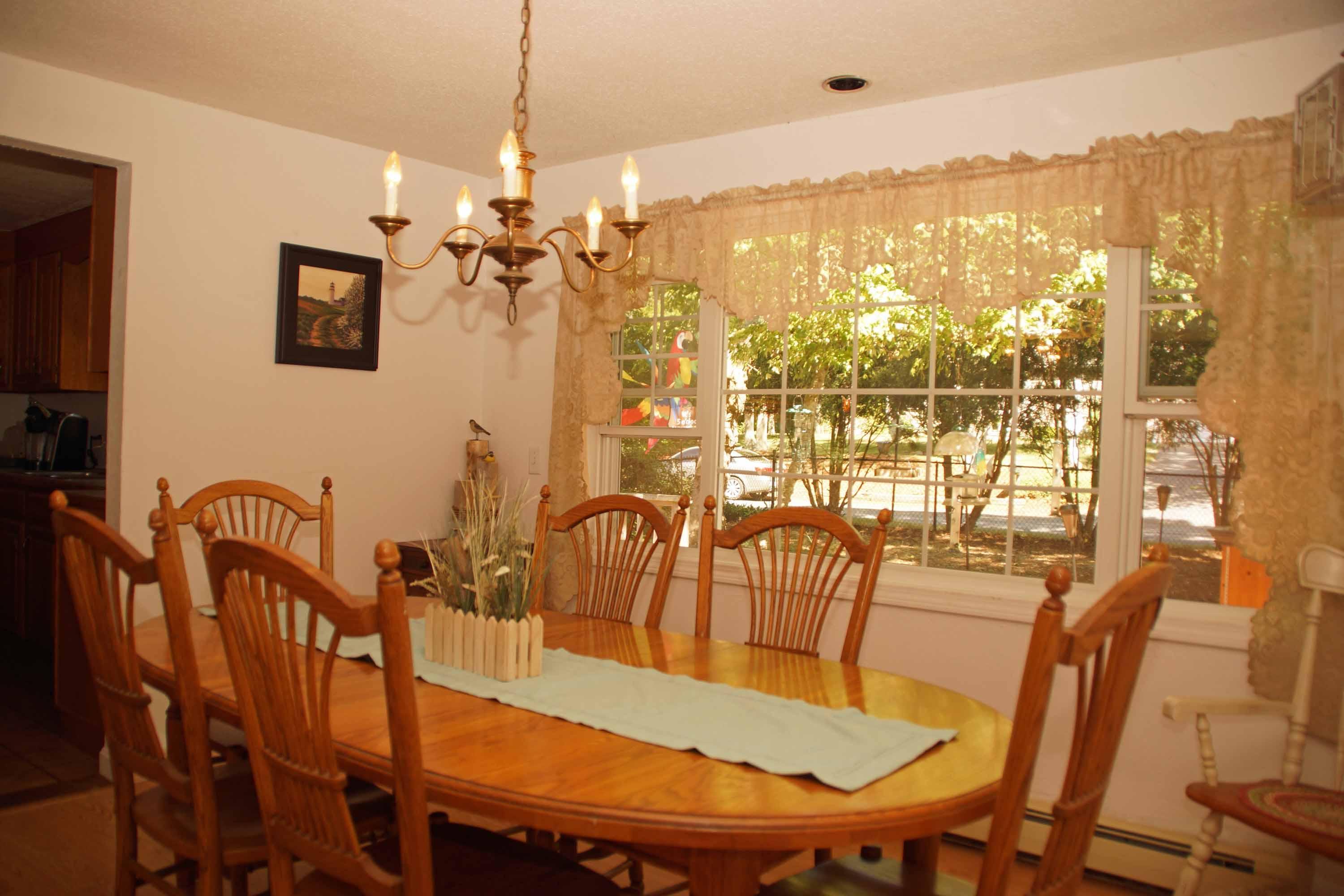 111 Azalea Drive Harwich, MA 02645 - Photo 9 of 26 a view of a dining room with furniture window and outside view