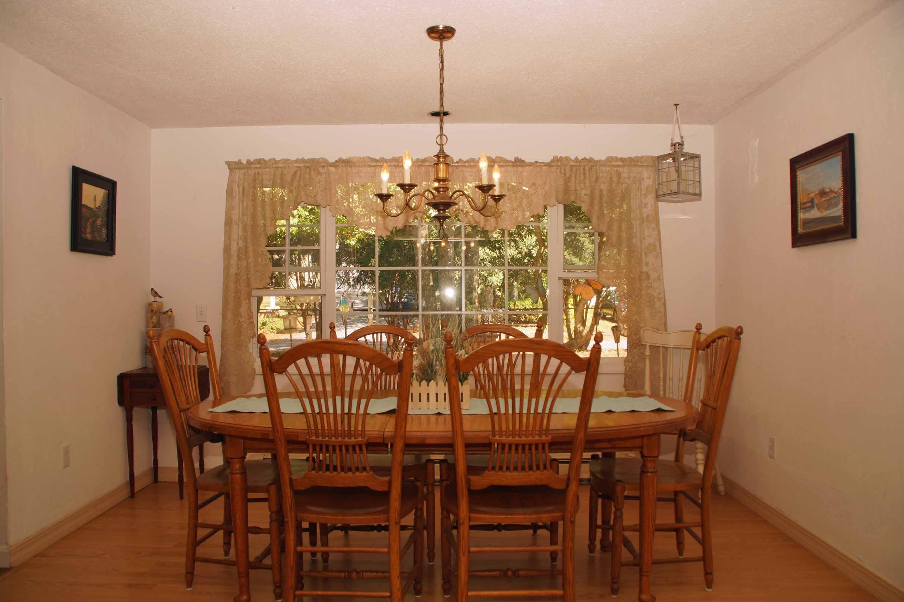 111 Azalea Drive Harwich, MA 02645 - Photo 10 of 26 a view of a dining room with furniture and chandelier