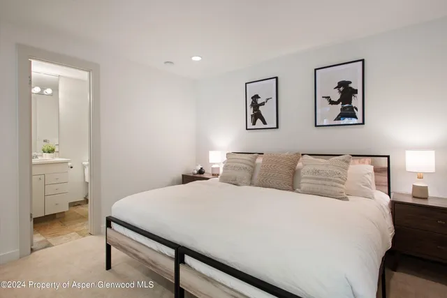 a bedroom with a bed and bathroom