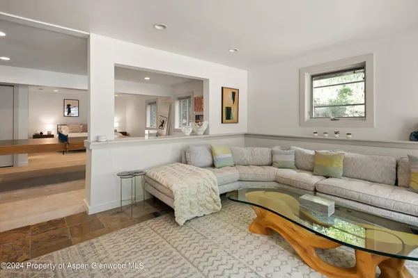 a living room with a couch and a mirror