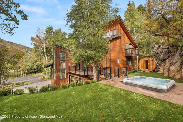a backyard of a house with table and chairs
