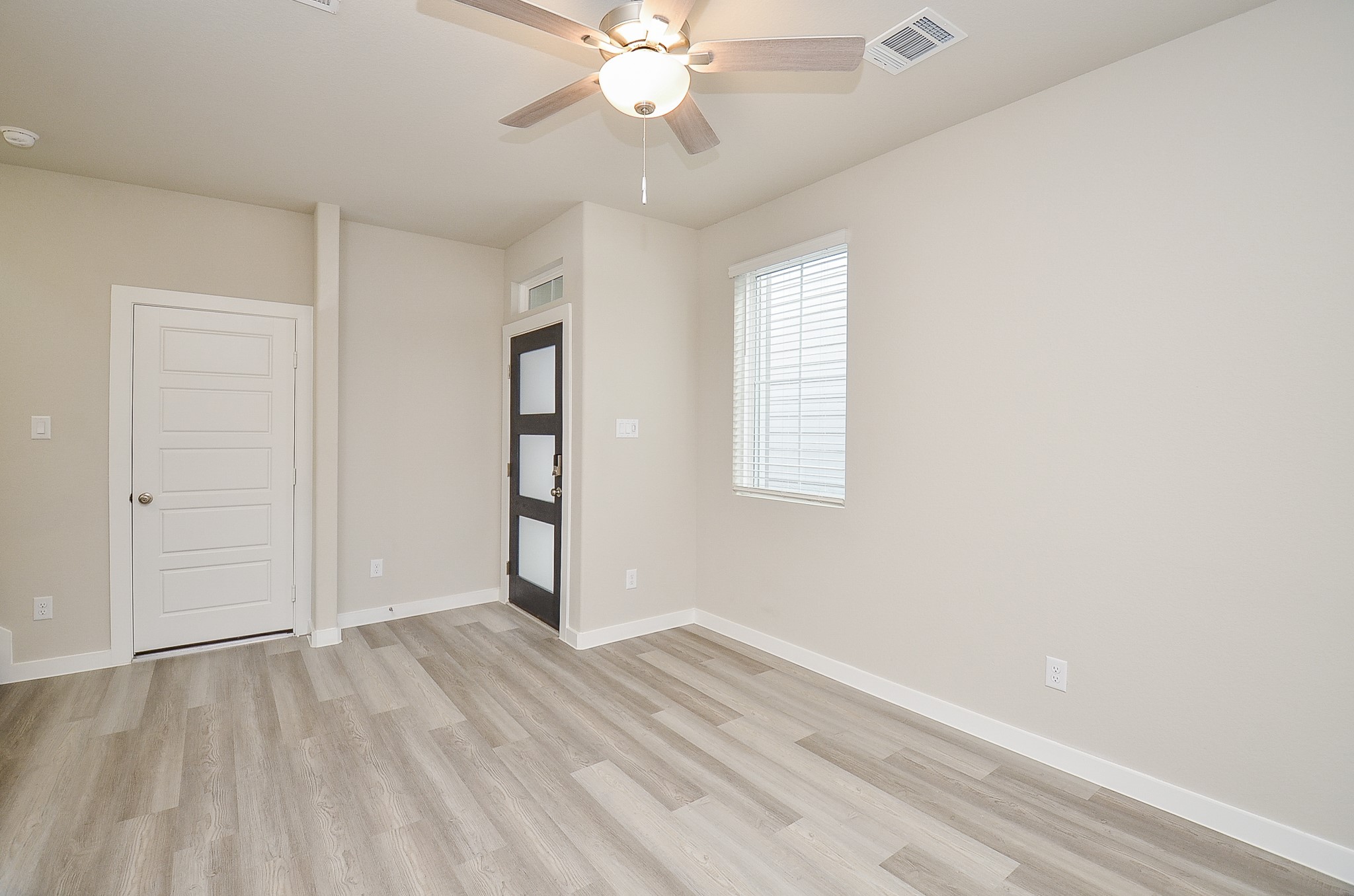 3107 Boulder Rnch Drive Houston, TX 77063 - Photo 11 of 40 wooden floor in an empty room with a window