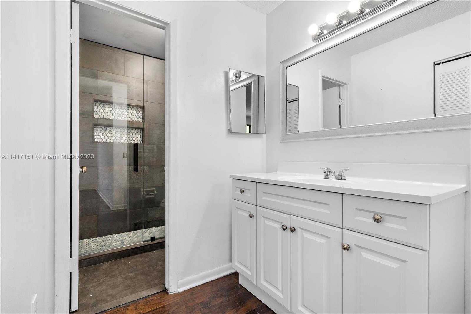9435 Southwest 151st Avenue Miami, FL 33196 - Photo 12 of 35 a bathroom with a shower sink and mirror