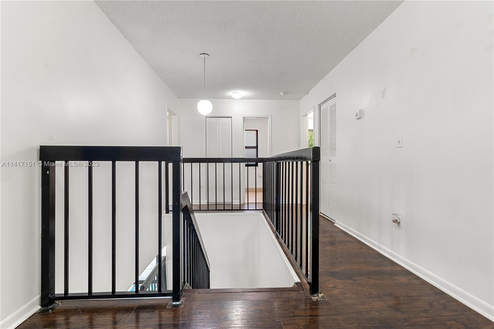 9435 Southwest 151st Avenue Miami, FL 33196 - Photo 14 of 35 a view of a hallway with wooden floor