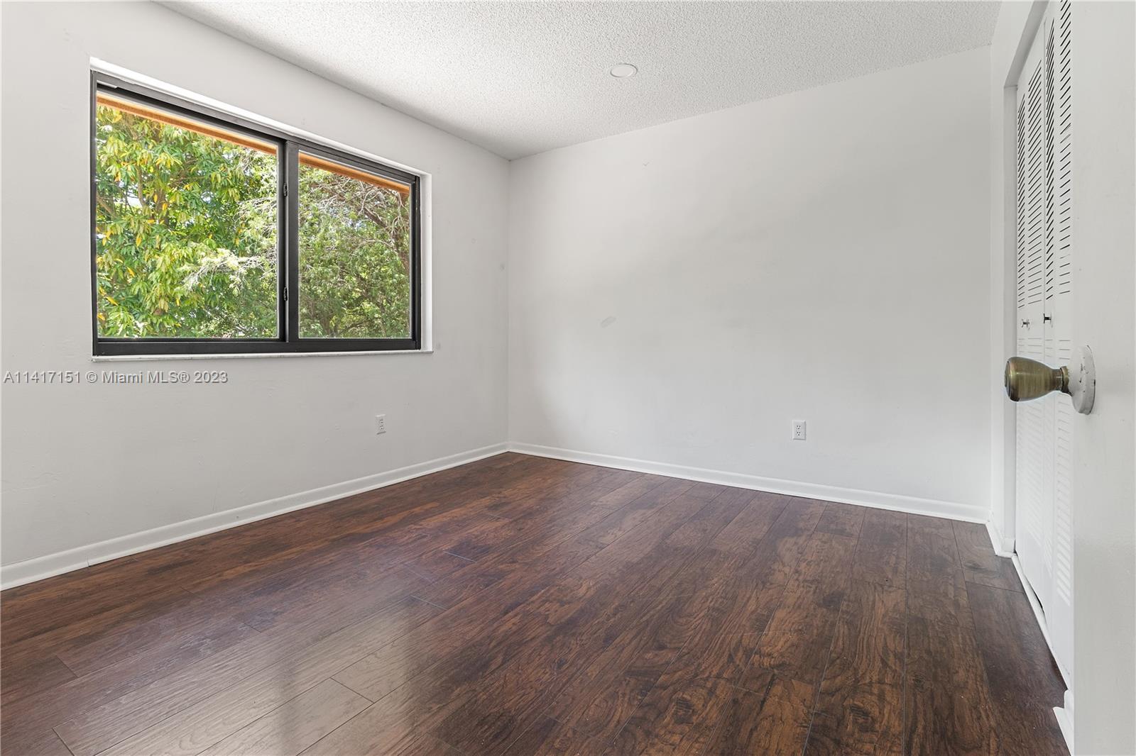 9435 Southwest 151st Avenue Miami, FL 33196 - Photo 17 of 35 wooden floor in an empty room with a window