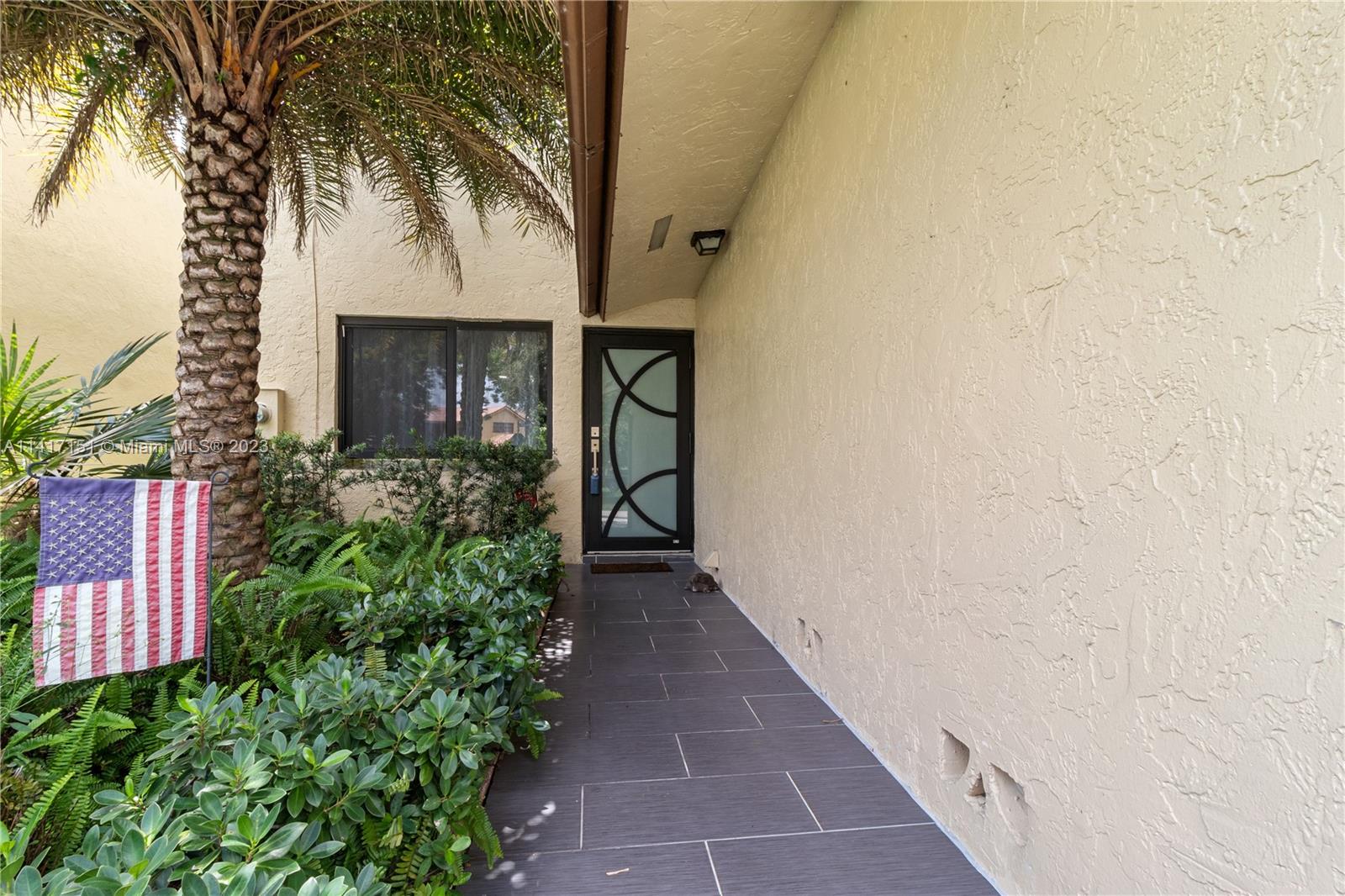 9435 Southwest 151st Avenue Miami, FL 33196 - Photo 20 of 35 a view of entryway with flower plants