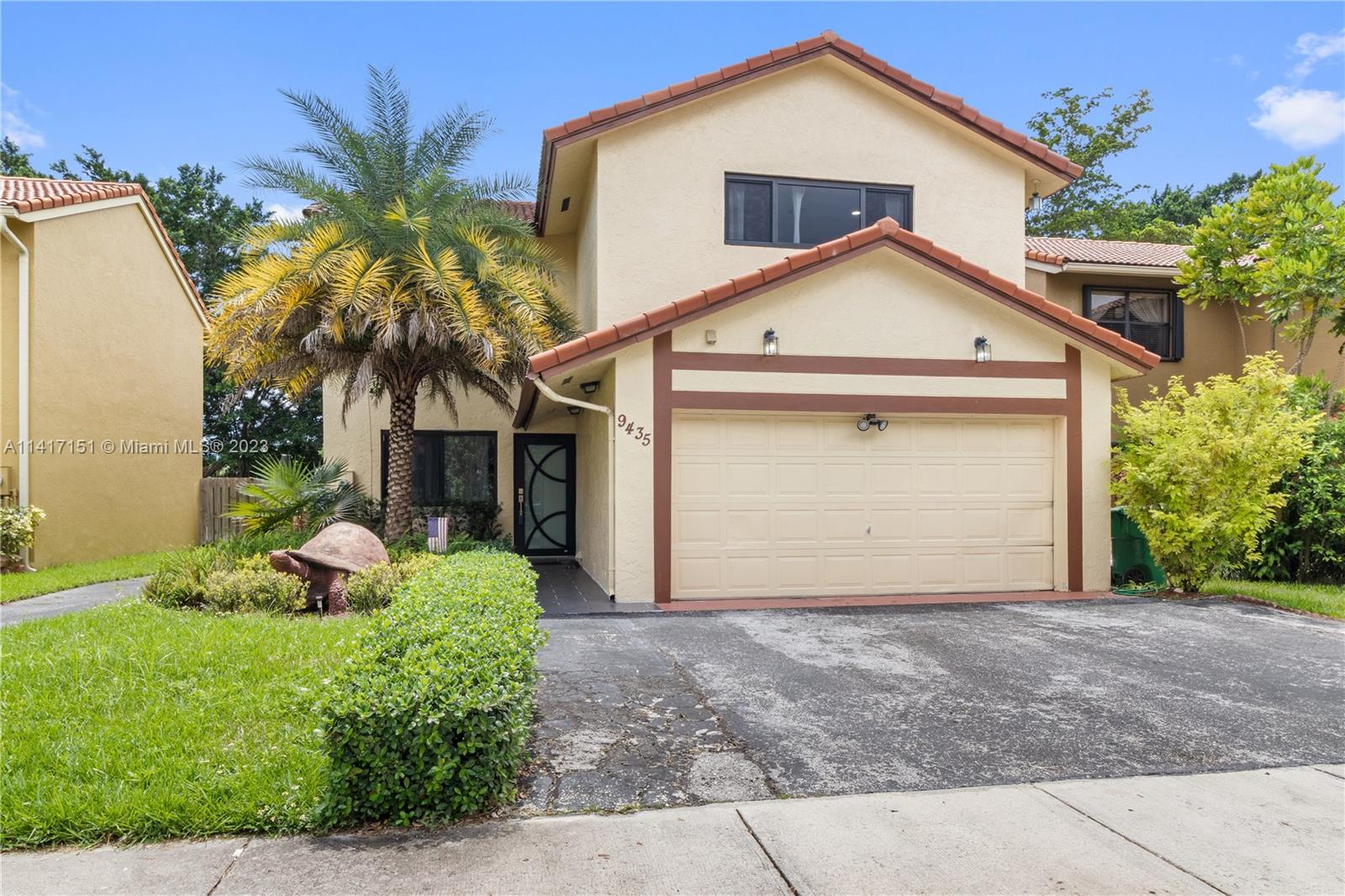 9435 Southwest 151st Avenue Miami, FL 33196 - Photo 21 of 35 a front view of a house with a yard and garage