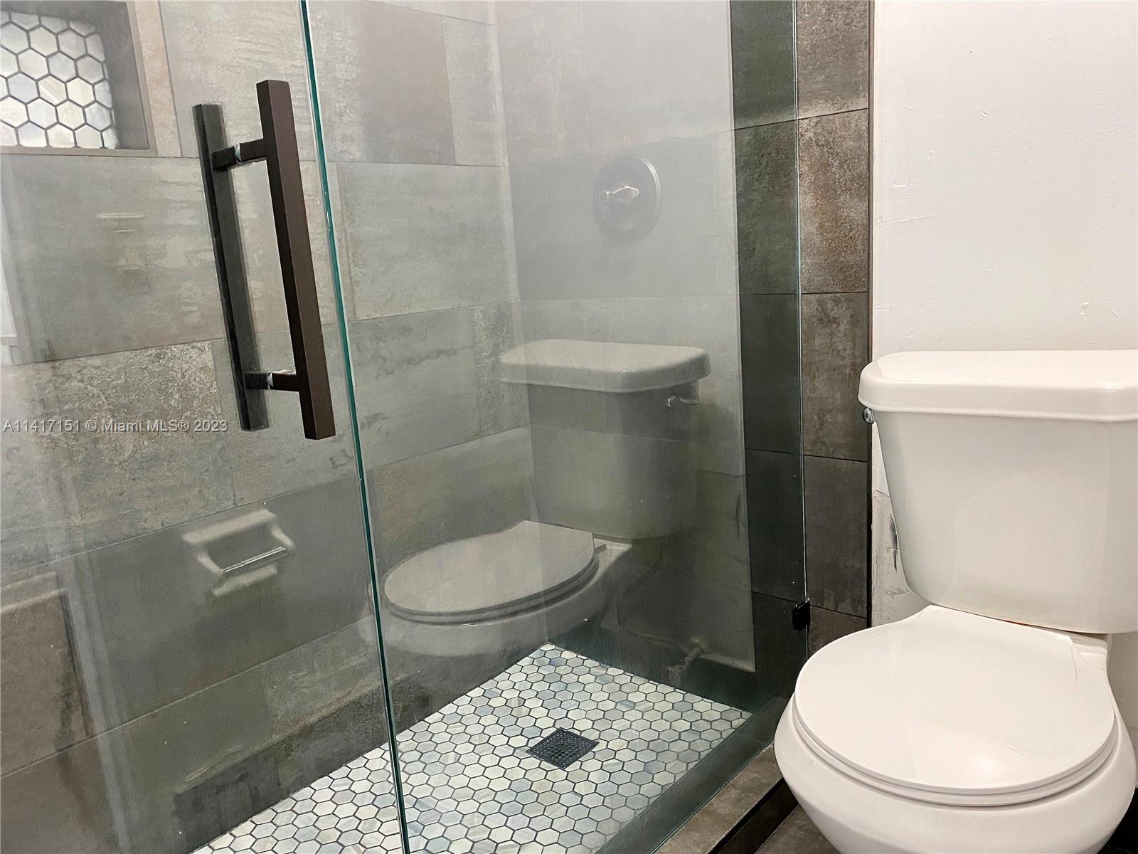 9435 Southwest 151st Avenue Miami, FL 33196 - Photo 31 of 35 a bathroom with a toilet and a shower