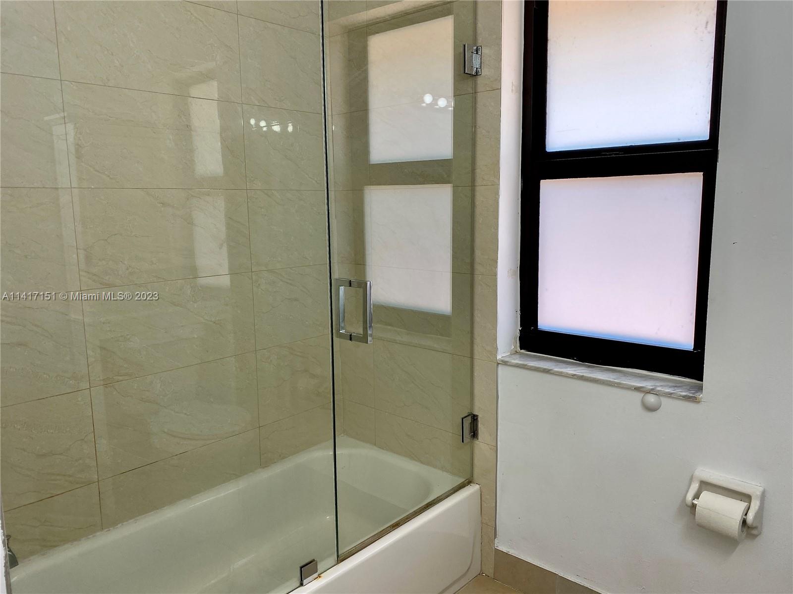 9435 Southwest 151st Avenue Miami, FL 33196 - Photo 33 of 35 a bathroom with a bathtub and a shower