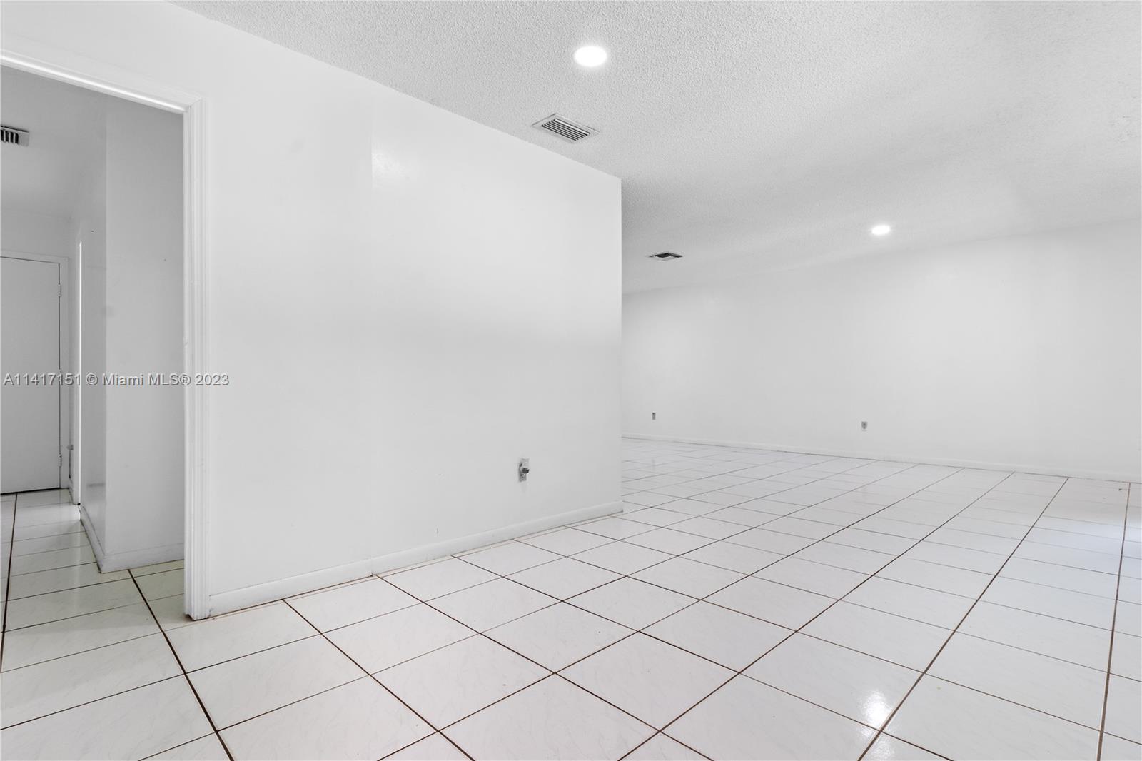 9435 Southwest 151st Avenue Miami, FL 33196 - Photo 4 of 35 an empty room with white walls