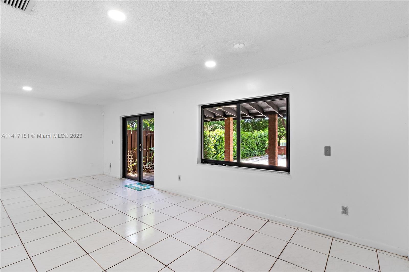 9435 Southwest 151st Avenue Miami, FL 33196 - Photo 9 of 35 a view of an empty room with a window